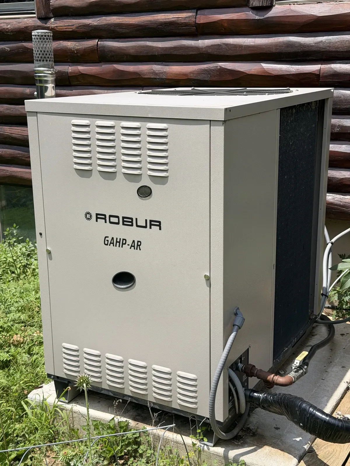 Robur GAHP-AR gas absorption heat pump outdoor unit on its concrete pad