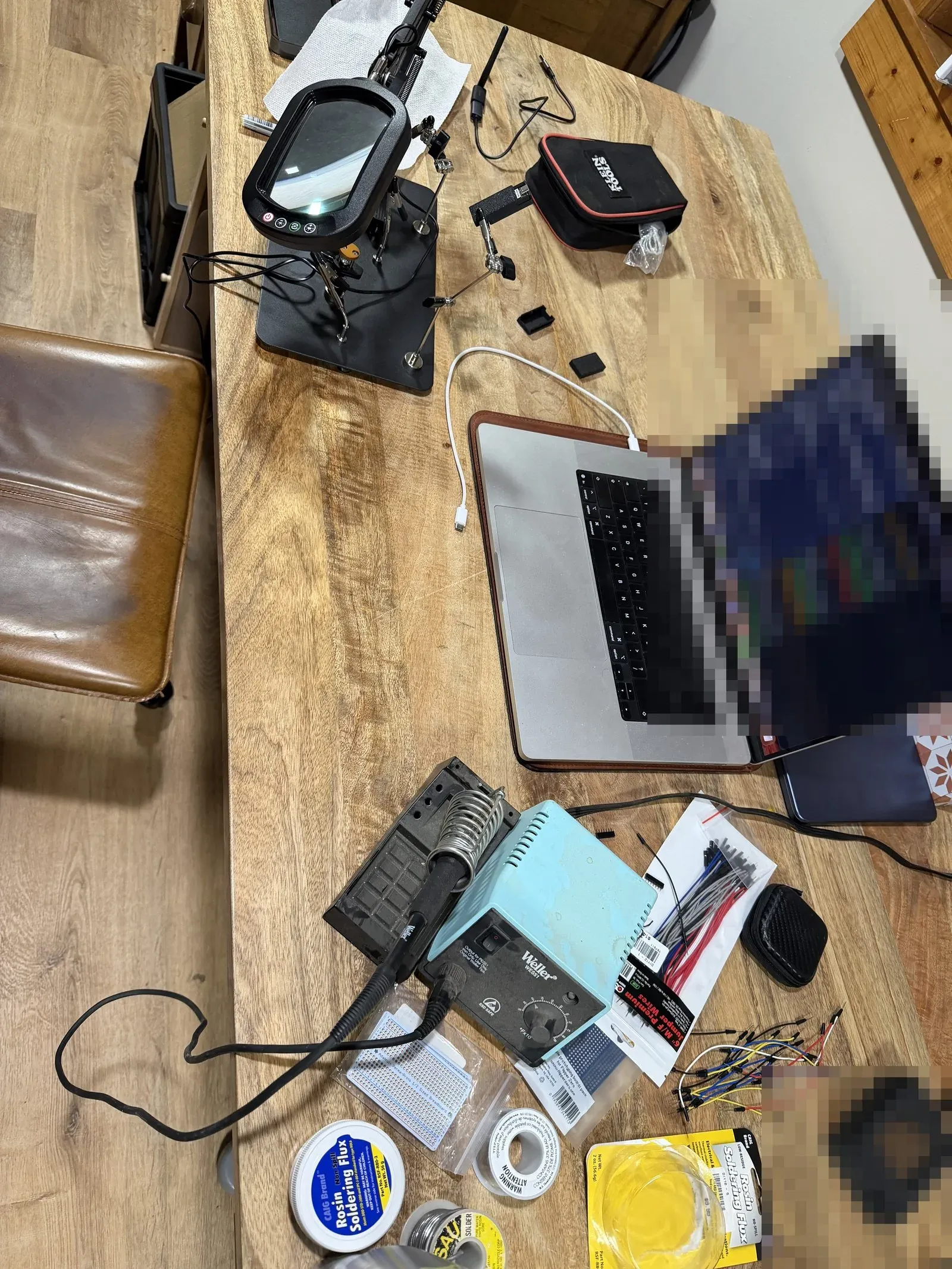 Workbench with a soldering station and the voltage dividers mid-assembly
